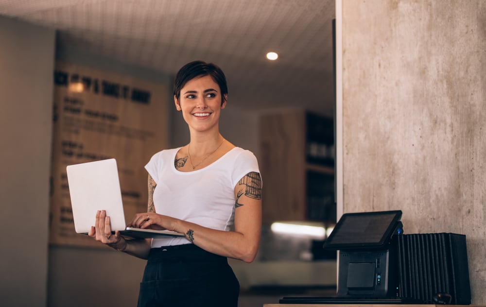 Woman smiling with her 2 2 3 schedule in hand